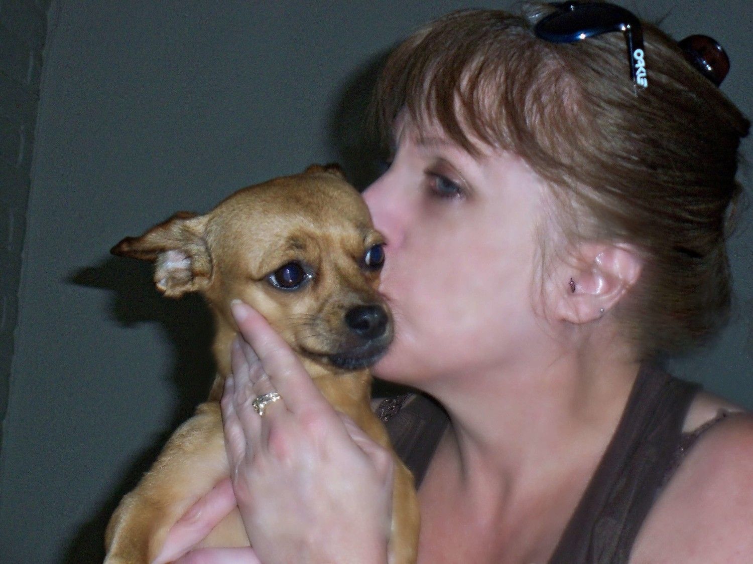 Lady kissing a puppy