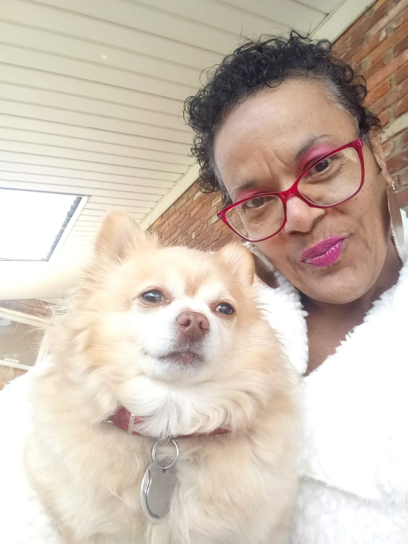 A dog is sitting on a woman's lap